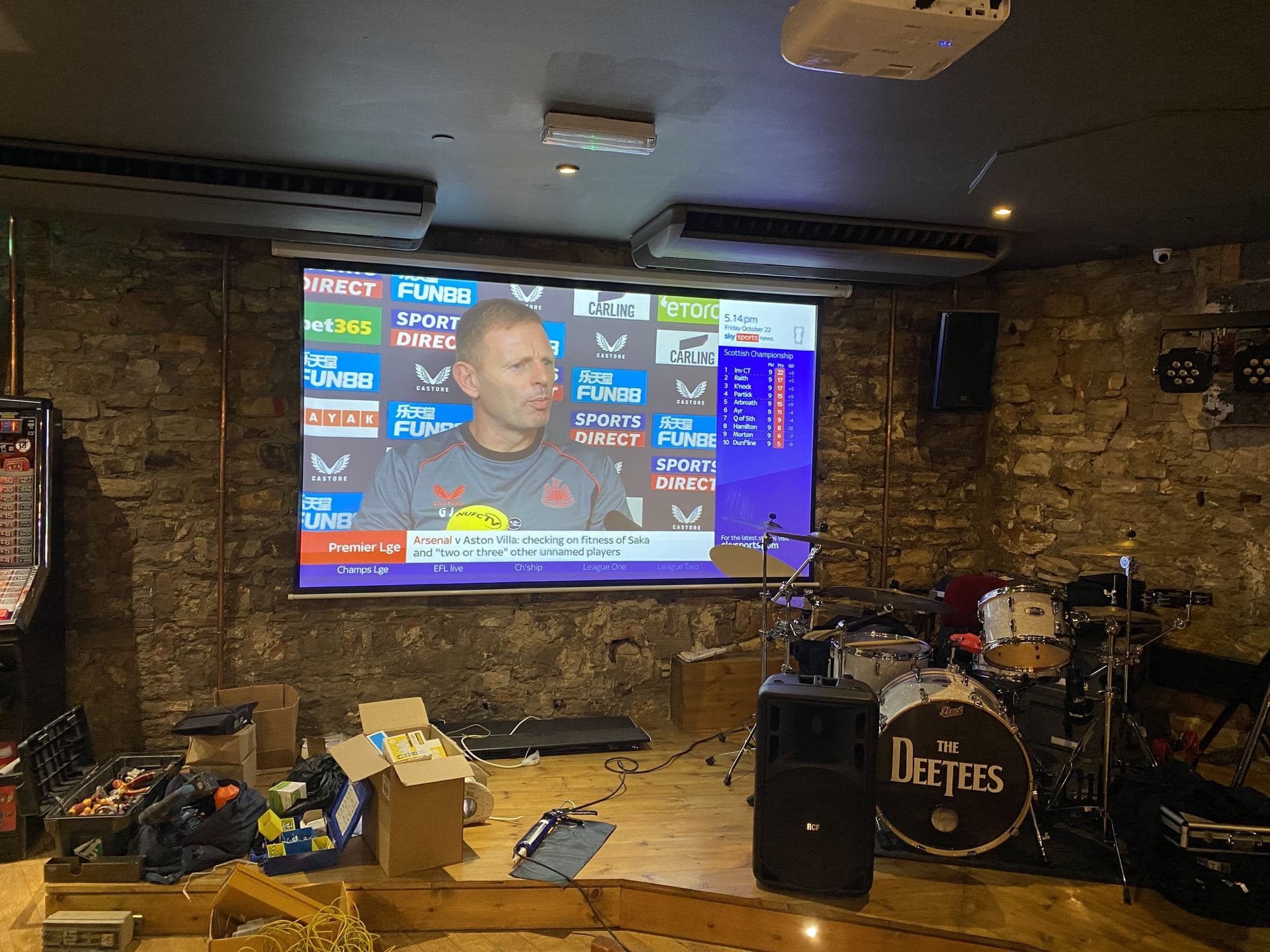Live music stage with projector screen and PA speaker