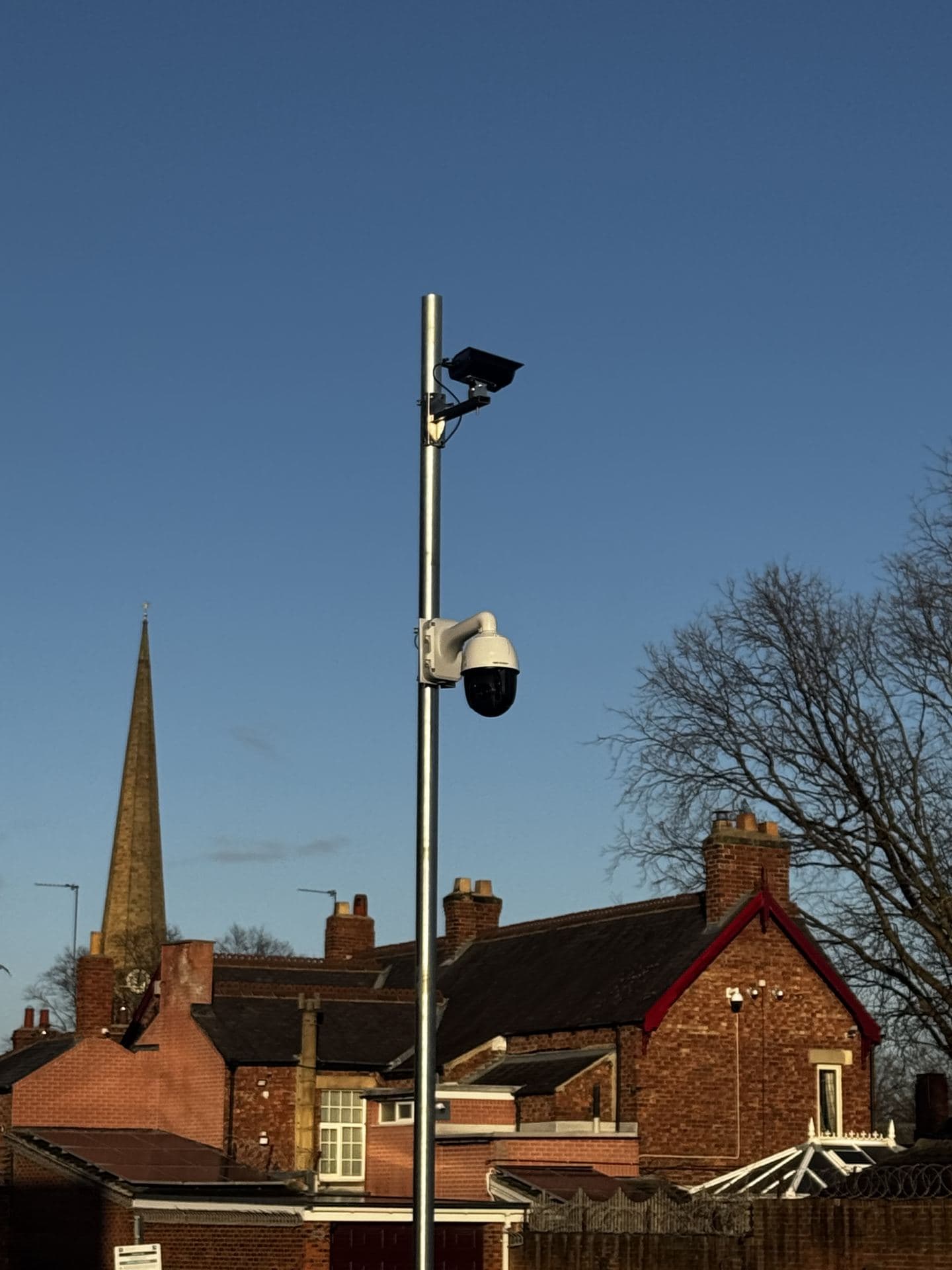 CCTV camera mounted on a pole overlooking a town centre