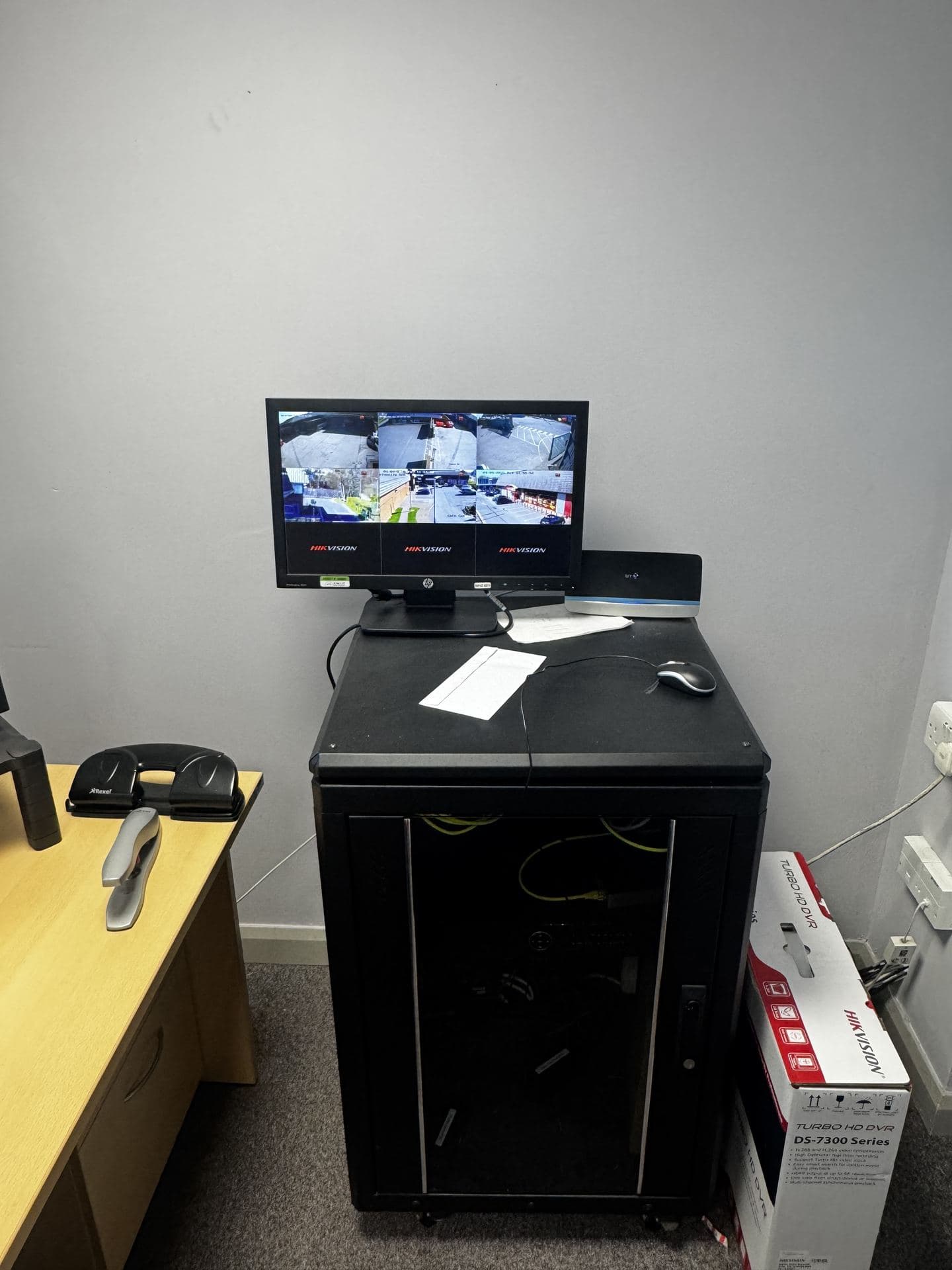 Hikvision monitor and NVR cabinet in an office