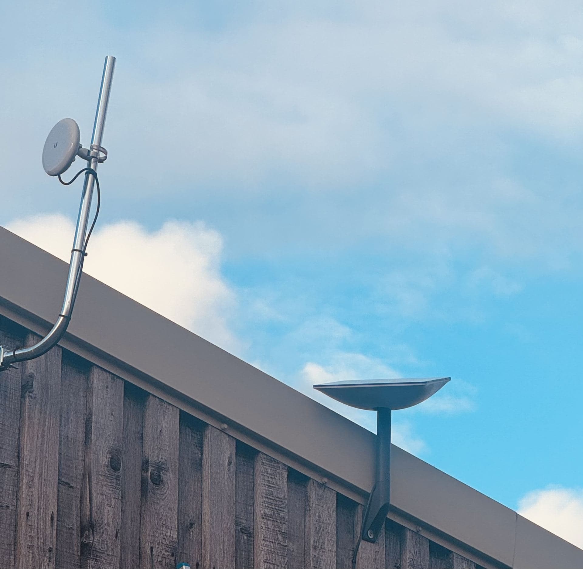 Point-to-point wireless dish mounted on a roofline